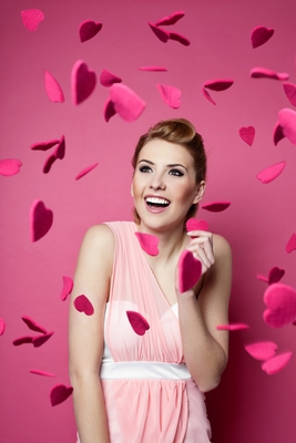 woman surrounded in heart petals